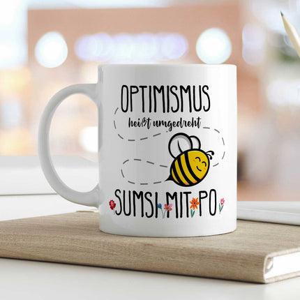 SEO. Bedruckte Tasse mit Spruch - Optimismus heißt umgedreht Sumsi mit Po - Weiß Linkreich